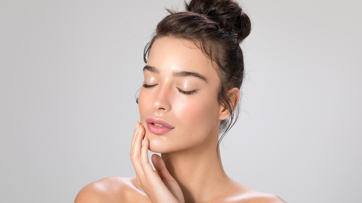 Woman with glowing skin and closed eyes