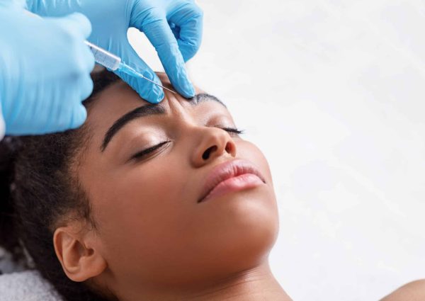 Plastic,Surgery.,Young,African,Woman,Receiving,Botox,Injection,In,Interbrow